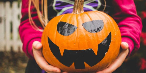 girl holding a pumpkin