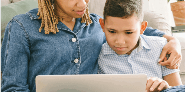 Young boy launching a DIY fundraising page with his mom