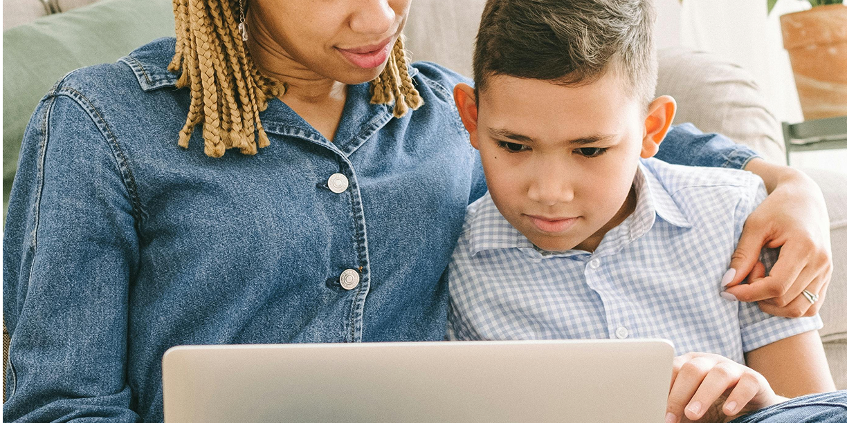 Young boy launching a DIY fundraising page with his mom