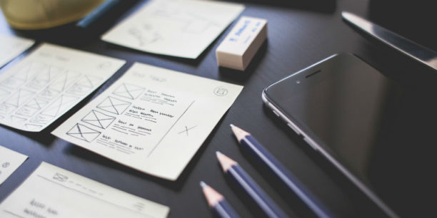 phone, pencils, paper desk setup