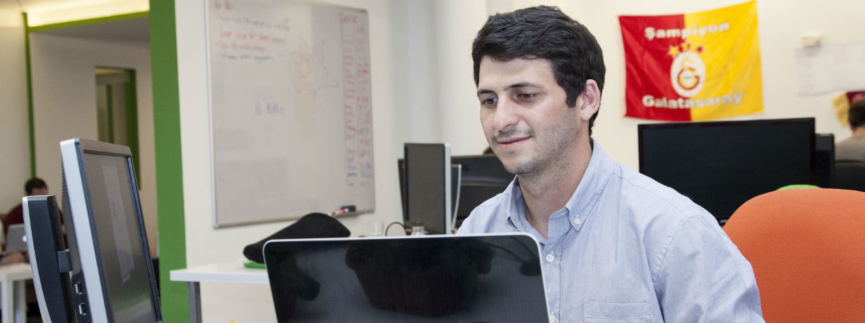 Man sitting at a desk looking on his computer