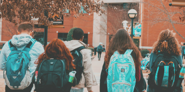 kids walking to school with backpacks on