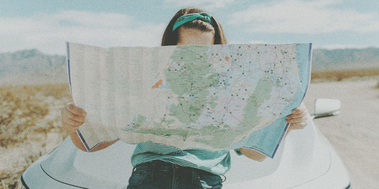 woman outside looking at a map