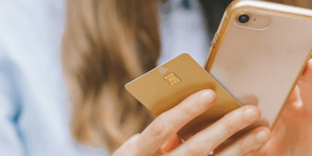hand holding phone and credit card