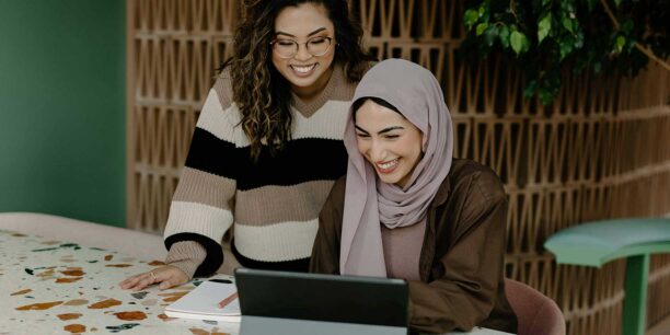 Two people using a tablet