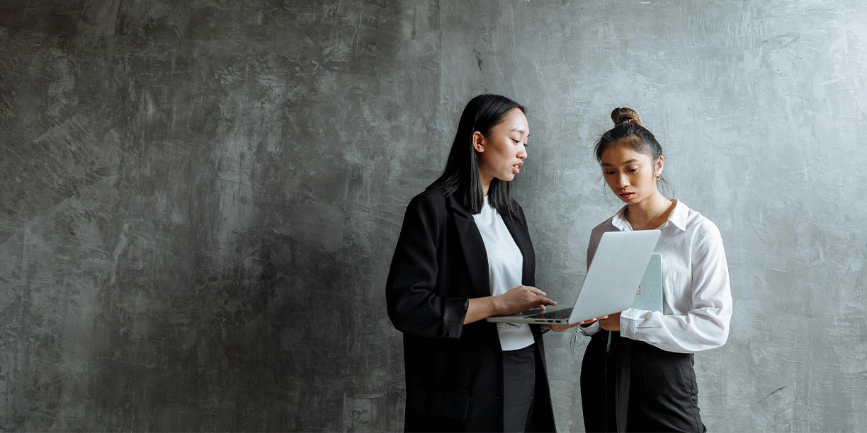 Women standing in the office discussing nonprofit grants to apply for