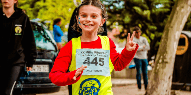 girl holding piece sign while running