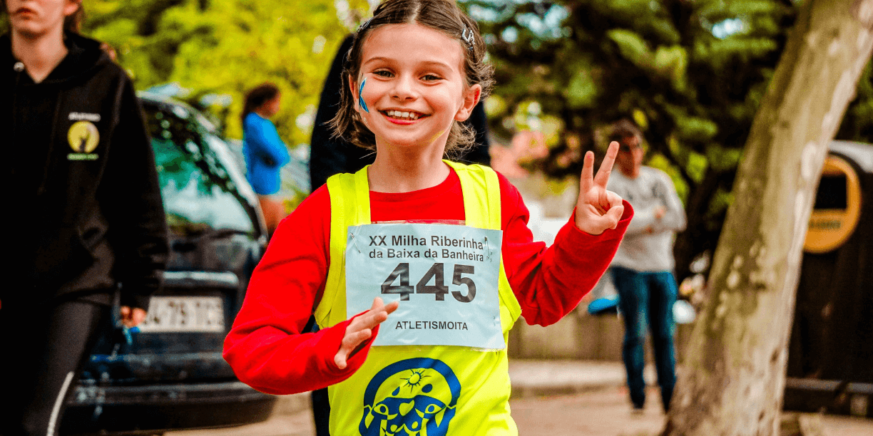 girl holding piece sign while running