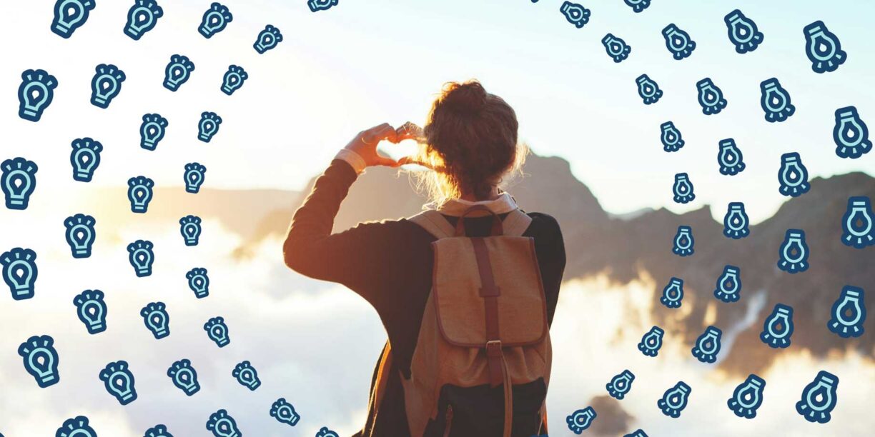 A hiker making a heart with their hands