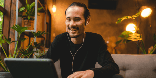 Man smiling at a his work station