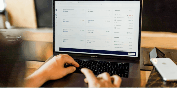 Hands typing on a laptop